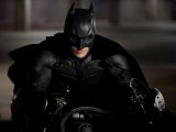 Christian Bale as Batman, riding the Batpod