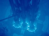 The ghostly-blue glow is given by Cherenkov radiation in the water cooling an experimental nuclear reactor
