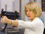 No other woman can be as glamorous as Mirren in evening gown matched with red lipstick and machine gun
