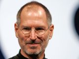 Steve Jobs (Apple logo in the background)