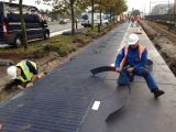 The bike path is made of concrete slabs that have solar cells embedded in them