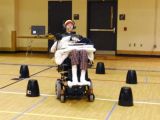 Cruise Bogle, a participant in the clinical trial at the Shepherd Center, moves his tongue to direct the Tongue Drive system to move the powered wheelchair around the obstacle course