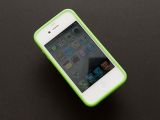 White iPhone 4 wearing a green bumper