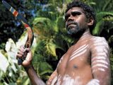 Aborigine launching a decorated boomerang