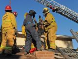 Photo shows firefighters pulling the woman out of the chimney