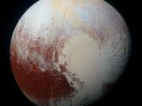 Pluto comes in hints of pale blue, yellow, orange and red