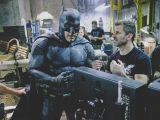 Director Zack Snyder talks to Ben Affleck in Batman costume, on the set of “Batman V. Superman”