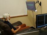 University of Washington graduate student Jose Ceballos wears an electroencephalography (EEG) cap that records brain activity