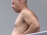 Vin Diesel in Miami, having a smoke on a balcony